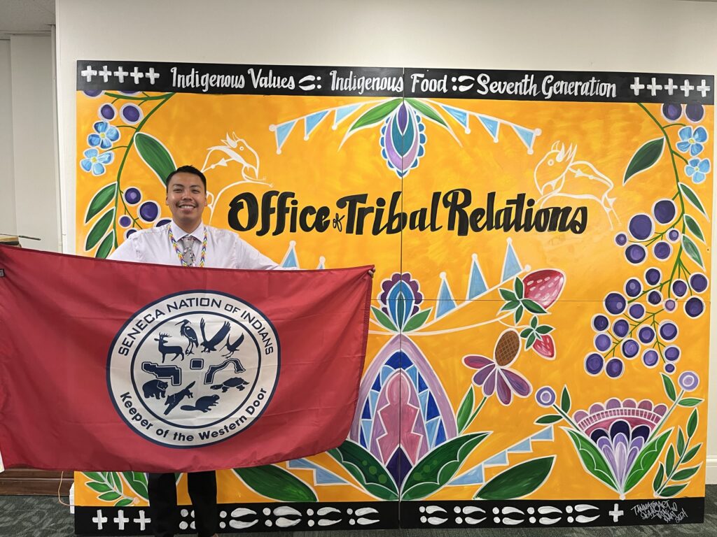 USDA intern holding Seneca Nation flag